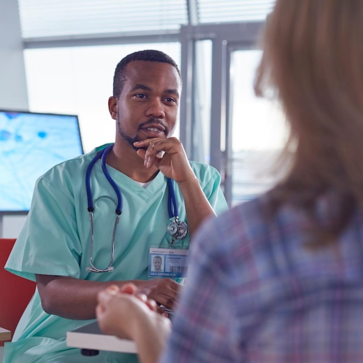 A doctor meets with a patient